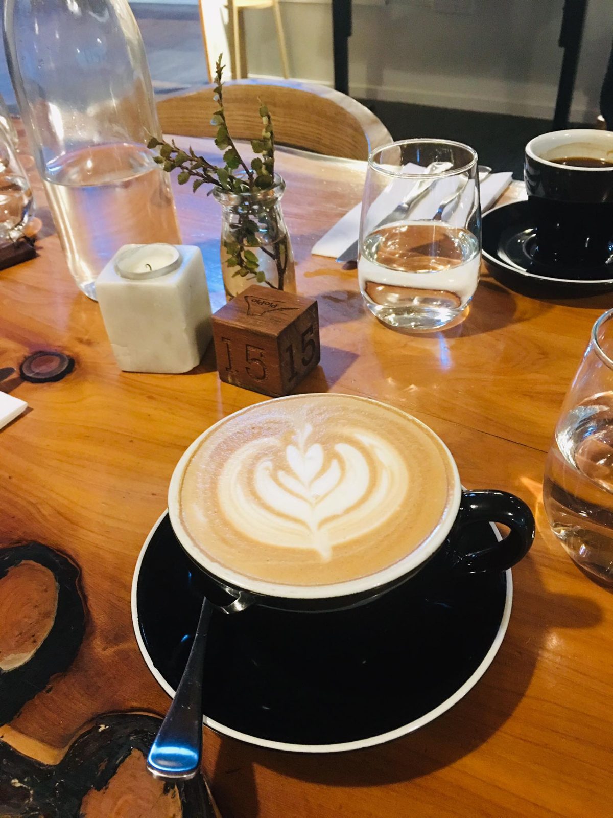 A flat white on a cafe table
